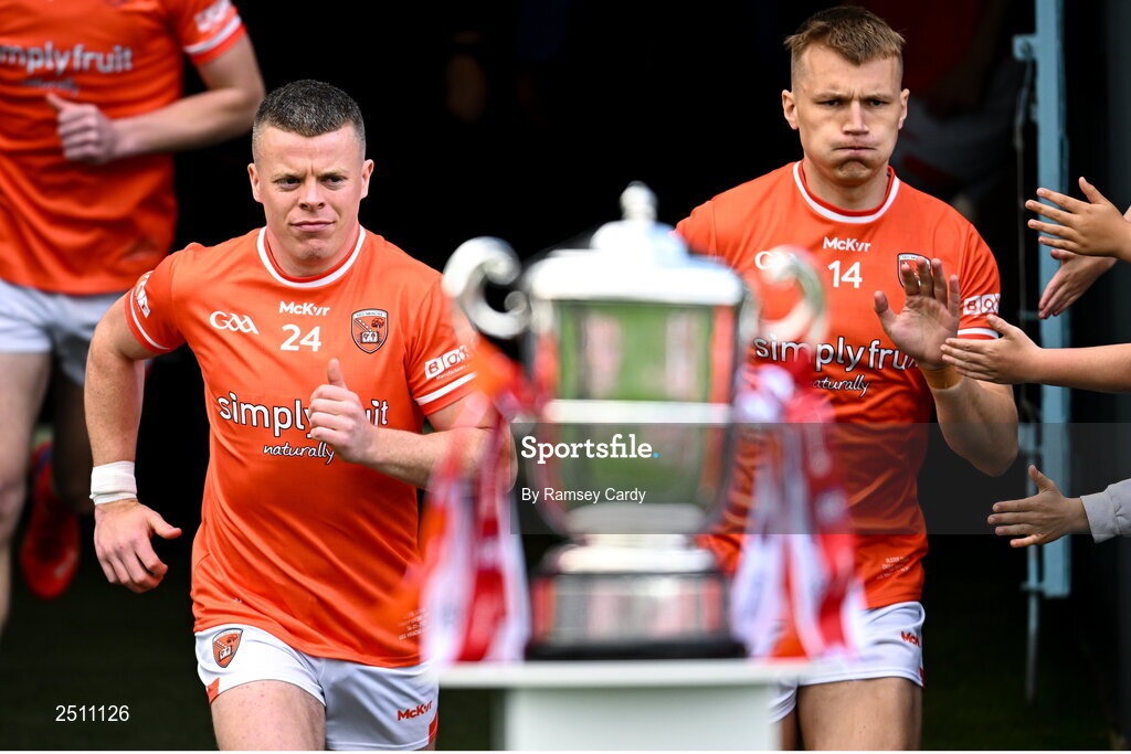 14 May 2023; Armagh joint-captains Aidan Nugent, left, and Rian O'Neill run past the Anglo Celt cup before the Ulster GAA Football Senior Championship Final match between Armagh and Derry at St Tiernach’s Park in Clones, Monaghan. Photo by Ramsey Cardy/Sportsfile