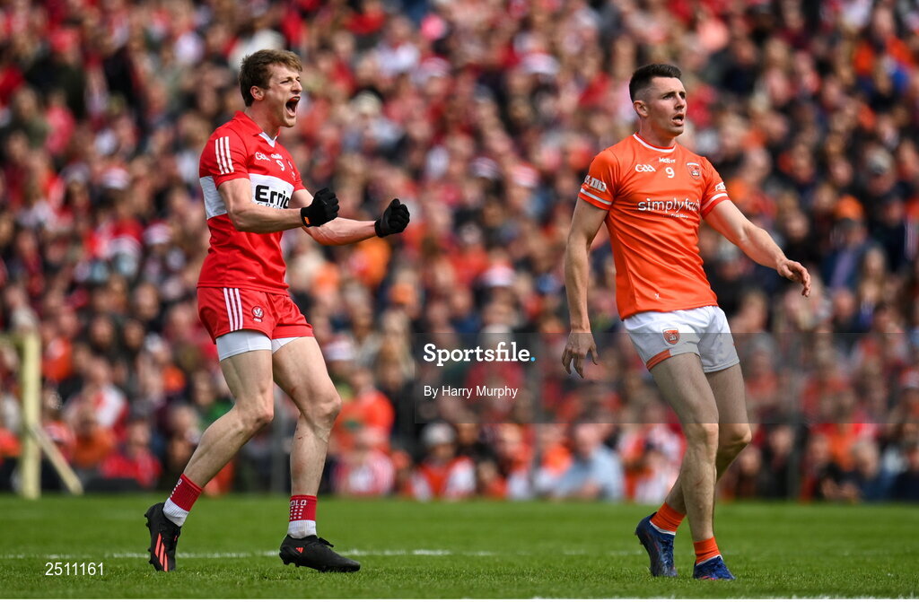 14 May 2023; Brendan Rogers of Derry celebrates scoring a point as Shane McPartlan of Armagh looks on during the Ulster GAA Football Senior Championship Final match between Armagh and Derry at St Tiernach’s Park in Clones, Monaghan. Photo by Harry Murphy/Sportsfile