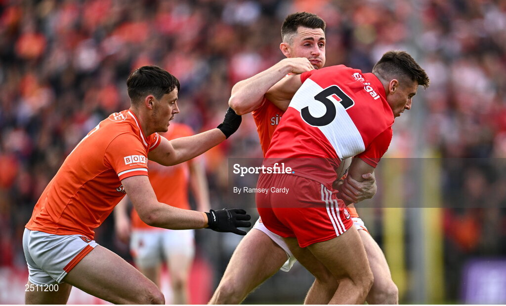 14 May 2023; Conor Doherty of Derry is tackled by Aaron McKay, left, and Shane McPartlan of Armagh during the Ulster GAA Football Senior Championship Final match between Armagh and Derry at St Tiernach’s Park in Clones, Monaghan. Photo by Ramsey Cardy/Sportsfile