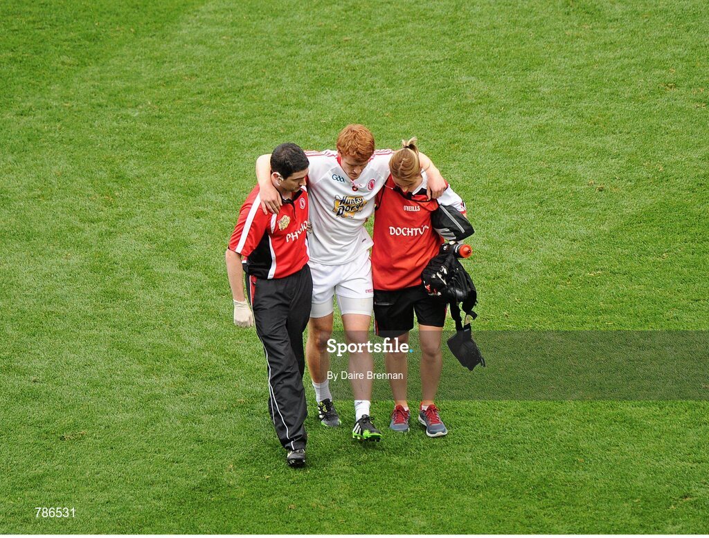 25 August 2013; Peter Harte, Tyrone, is escorted off the pitch by physio Michael Harte and team doctor Dr. Liz O'Brien, after picking up an injury in the fifth minute. GAA Football All-Ireland Senior Championship Semi-Final, Mayo v Tyrone, Croke Park, Dublin. Picture credit: Dáire Brennan / SPORTSFILE