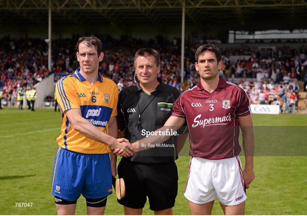 28 July 2013; Clare captain Patrick Donnellan and Galway captain Fergal Moore shake hands in front of referee Brian Gavin. GAA Hurling All-Ireland Senior Championship, Quarter-Final, Galway v Clare, Semple Stadium, Thurles, Co. Tipperary. Picture credit: Ray McManus / SPORTSFILE
