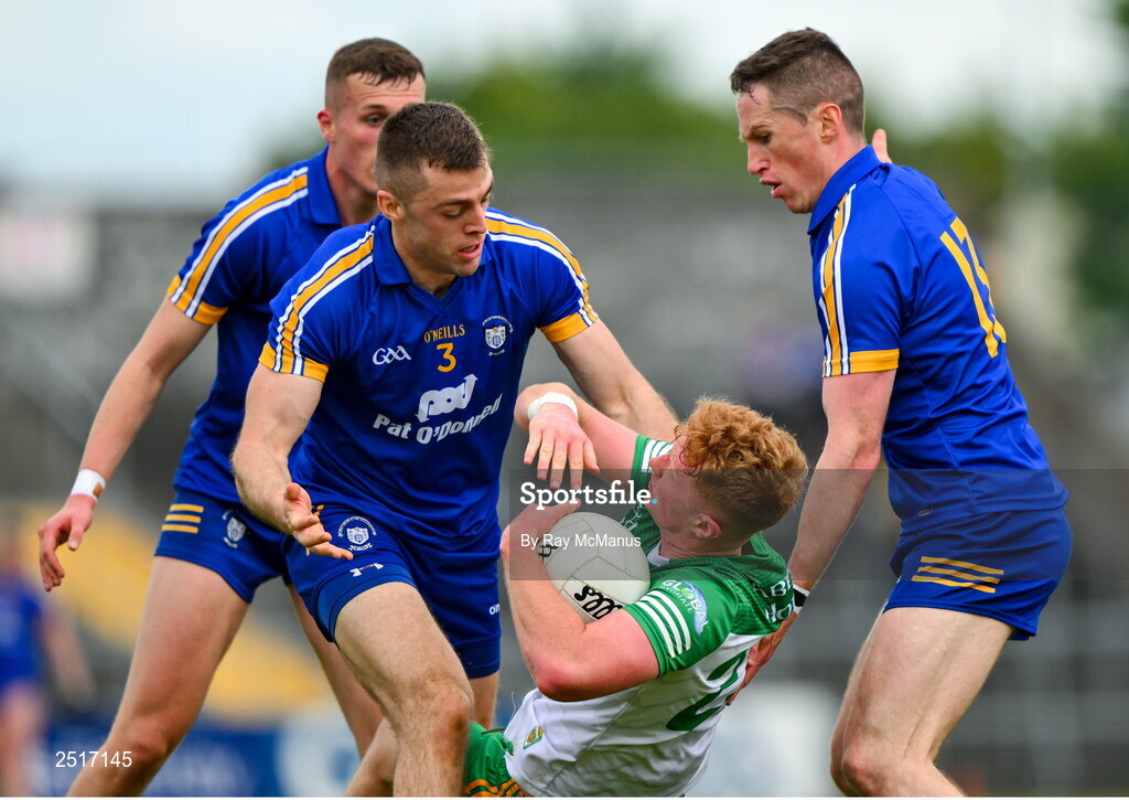 20 May 2023; Oisin Gallen of Donegal is tackled by Clare players, Cillian Brennan, 3, Eoin Cleary, right, and Emmet McMahon during the GAA Football All-Ireland Senior Championship Round 1 match between Clare and Donegal at Cusack Park in Ennis, Clare. Photo by Ray McManus/Sportsfile