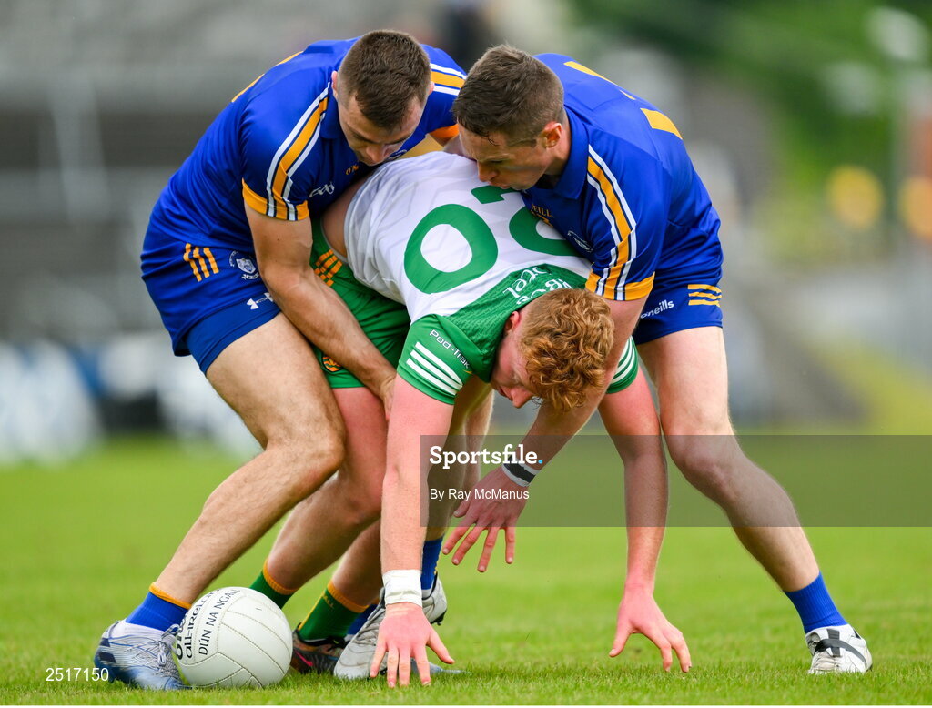 20 May 2023; Oisin Gallen of Donegal is tackled by Cillian Brennan, left, and Eoin Cleary of Clare during the GAA Football All-Ireland Senior Championship Round 1 match between Clare and Donegal at Cusack Park in Ennis, Clare. Photo by Ray McManus/Sportsfile