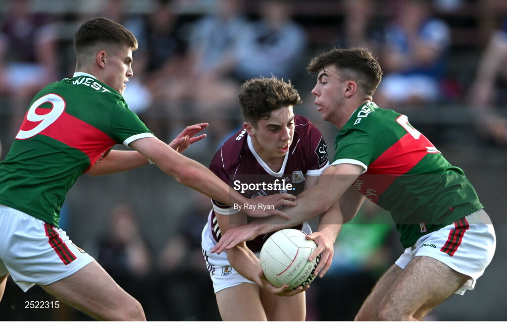 26 May 2023; Olan Kelly of Galway in action against Shane Cunningham, left, and Jamie Clarke of Mayo during the 2023 Electric Ireland Connacht GAA Football Minor Championship Final between Galway and Mayo at Tuam Stadium in Galway. Photo by Ray Ryan/Sportsfile
