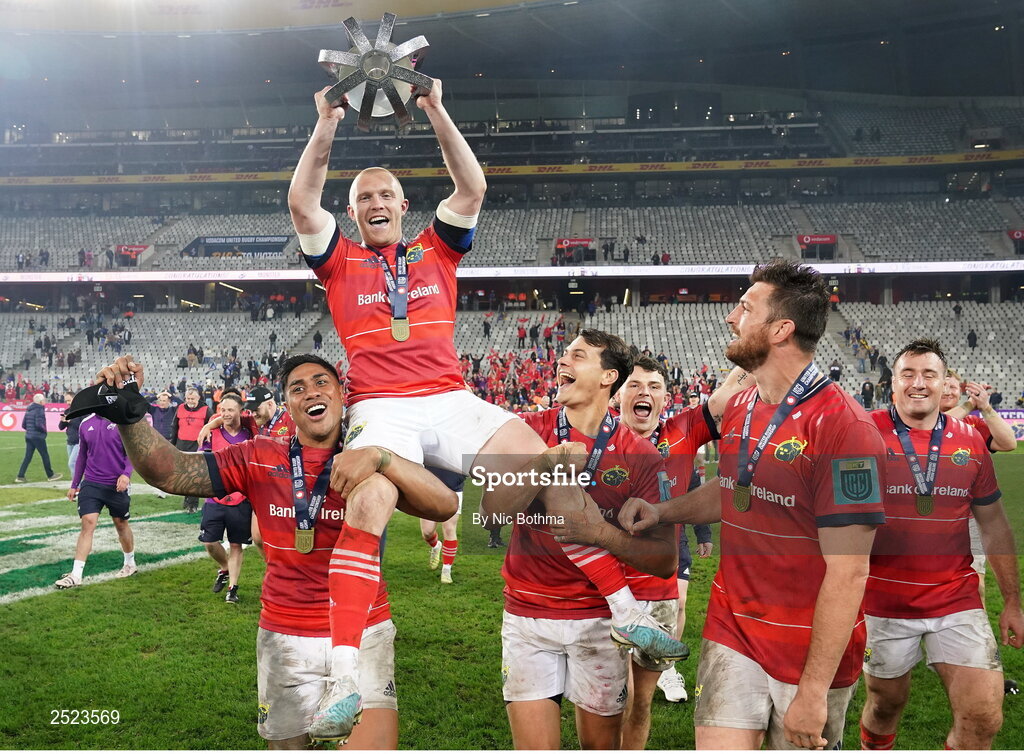 27 May 2023; Keith Earls of Munster is carried by teammates Malakai Fekitoa, left, and Antoine Frisch as they celebrate with the trophy afterthe United Rugby Championship Final match between DHL Stormers and Munster at DHL Stadium in Cape Town, South Africa. Photo by Nic Bothma/Sportsfile