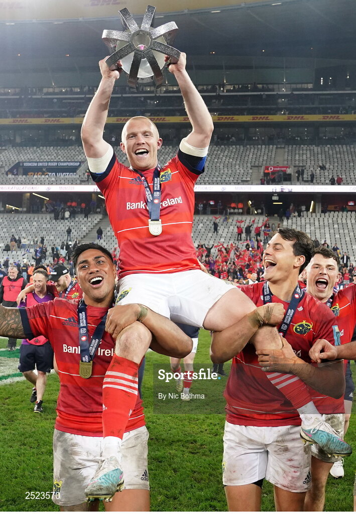 27 May 2023; Keith Earls of Munster is carried by teammates Malakai Fekitoa, left, and Antoine Frisch as they celebrate with the trophy afterthe United Rugby Championship Final match between DHL Stormers and Munster at DHL Stadium in Cape Town, South Africa. Photo by Nic Bothma/Sportsfile