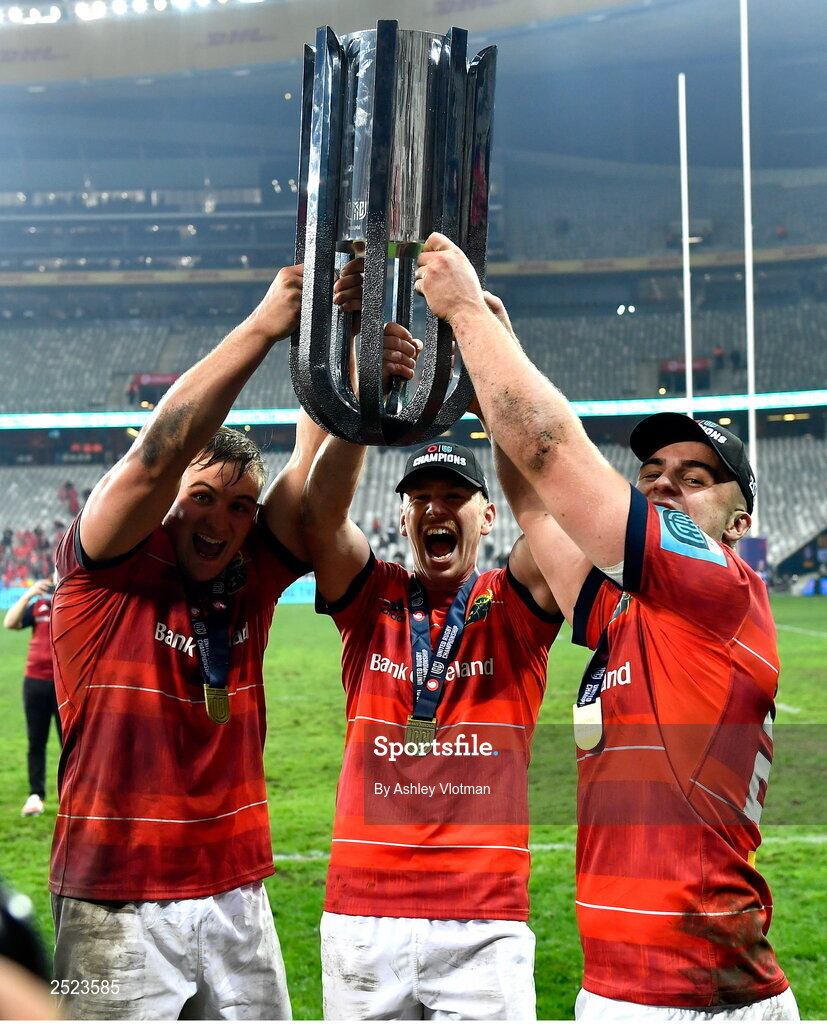 27 May 2023; Munster players, from left, Gavin Coombes, Ben Healy and Alex Kendellen celebrate with the trophy after the United Rugby Championship Final match between DHL Stormers and Munster at DHL Stadium in Cape Town, South Africa. Photo by Ashley Vlotman/Sportsfile