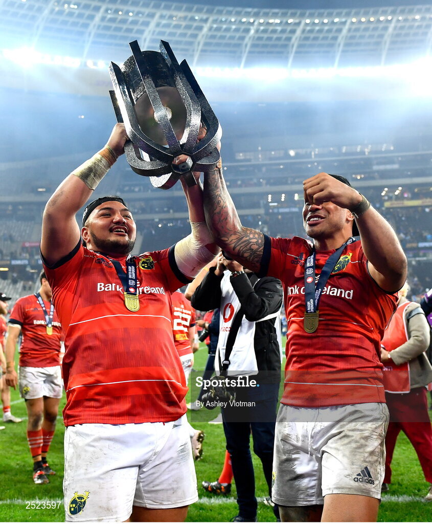 27 May 2023; Munster players Roman Salanoa, left, and Malakai Fekitoa celebrate with the trophy after the United Rugby Championship Final match between DHL Stormers and Munster at DHL Stadium in Cape Town, South Africa. Photo by Ashley Vlotman/Sportsfile