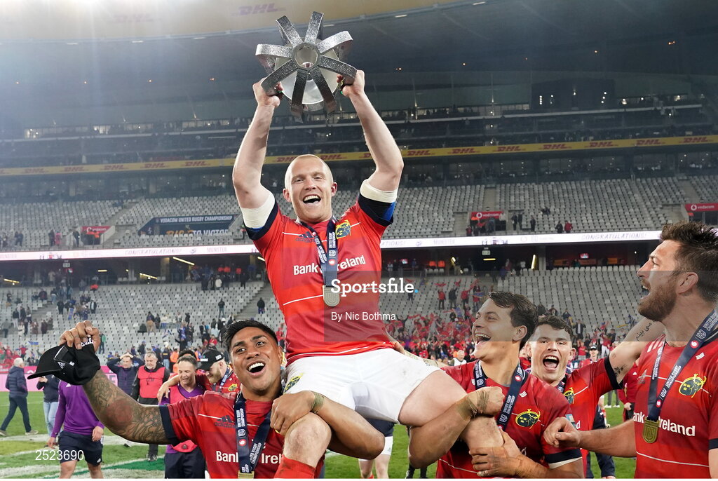 27 May 2023; Keith Earls of Munster is carried by teammates Malakai Fekitoa, left, and Antoine Frisch as they celebrate with the trophy afterthe United Rugby Championship Final match between DHL Stormers and Munster at DHL Stadium in Cape Town, South Africa. Photo by Nic Bothma/Sportsfile