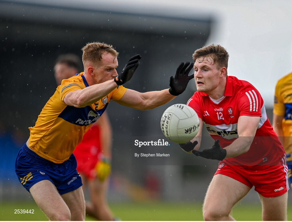 17 June 2023; Ethan Doherty of Derry in action against Pearse Lillis of Clare during the GAA Football All-Ireland Senior Championship Round 3 match between Derry and Clare at Glennon Brothers Pearse Park in Longford. Photo by Stephen Marken/Sportsfile