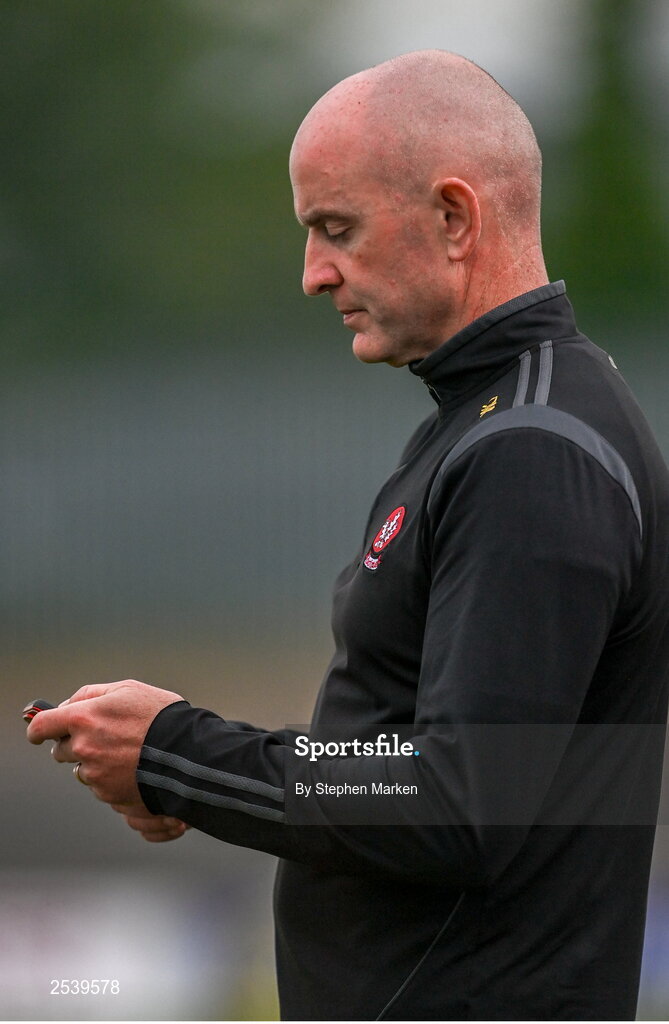 17 June 2023; Derry manager Ciaran Meenagh checks his phone during the GAA Football All-Ireland Senior Championship Round 3 match between Derry and Clare at Glennon Brothers Pearse Park in Longford. Photo by Stephen Marken/Sportsfile