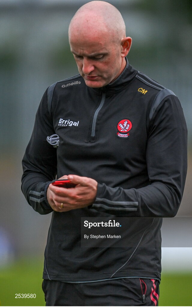 17 June 2023; Derry manager Ciaran Meenagh checks his phone during the GAA Football All-Ireland Senior Championship Round 3 match between Derry and Clare at Glennon Brothers Pearse Park in Longford. Photo by Stephen Marken/Sportsfile