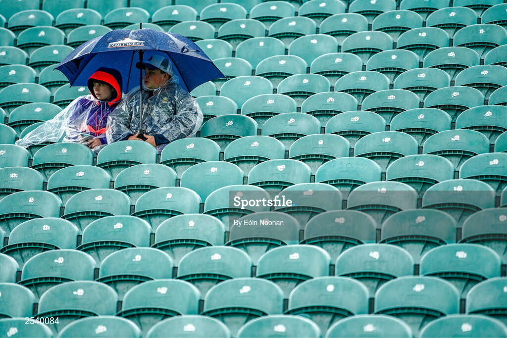 18 June 2023; Supporters take shelter from the rain before the GAA Football All-Ireland Senior Championship Round 3 match between Cork and Mayo at TUS Gaelic Grounds in Limerick. Photo by Eóin Noonan/Sportsfile