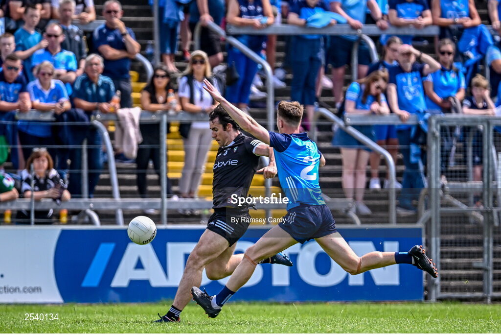 18 June 2023; Darragh Cummins of Sligo kicks his side's first point under pressure from Daire Newcombe of Dublin during the GAA Football All-Ireland Senior Championship Round 3 match between Dublin and Sligo at Kingspan Breffni in Cavan. Photo by Ramsey Cardy/Sportsfile