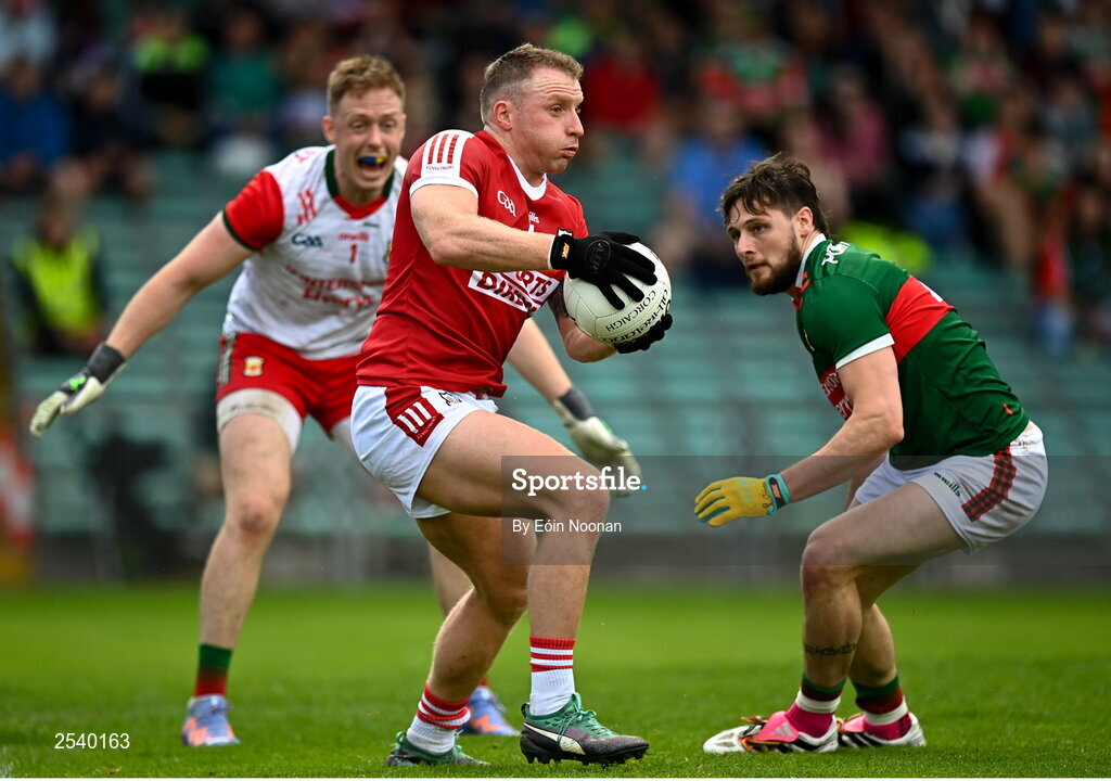 18 June 2023; Brian Hurley of Cork in action against Pádraig O’Hora of Mayo, right, and Mayo manager Colm Reape during the GAA Football All-Ireland Senior Championship Round 3 match between Cork and Mayo at TUS Gaelic Grounds in Limerick. Photo by Eóin Noonan/Sportsfile