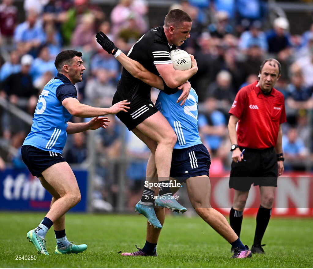 18 June 2023; Paul McNamara of Sligo is tackled by Colm Basquel, left, and Lorcan O'Dell of Dublin during the GAA Football All-Ireland Senior Championship Round 3 match between Dublin and Sligo at Kingspan Breffni in Cavan. Photo by Ramsey Cardy/Sportsfile