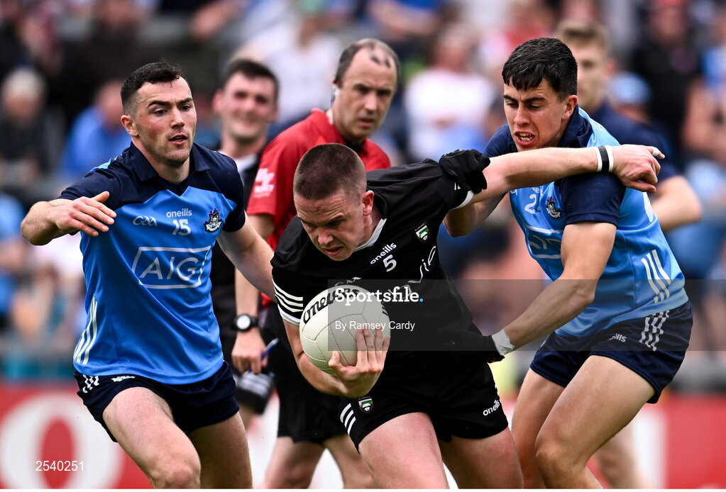 18 June 2023; Paul McNamara of Sligo is tackled by Colm Basquel, left, and Lorcan O'Dell of Dublin during the GAA Football All-Ireland Senior Championship Round 3 match between Dublin and Sligo at Kingspan Breffni in Cavan. Photo by Ramsey Cardy/Sportsfile