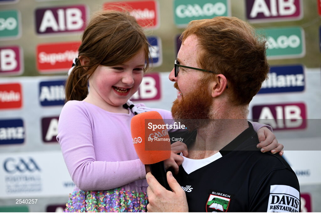 18 June 2023; 5 year old Meabh Devaney, niece of Sligo goalkeeper Aidan Devaney, is interviewed by her dad Stephen, from Calry, Sligo, during the GAA Football All-Ireland Senior Championship Round 3 match between Dublin and Sligo at Kingspan Breffni in Cavan. Photo by Ramsey Cardy/Sportsfile