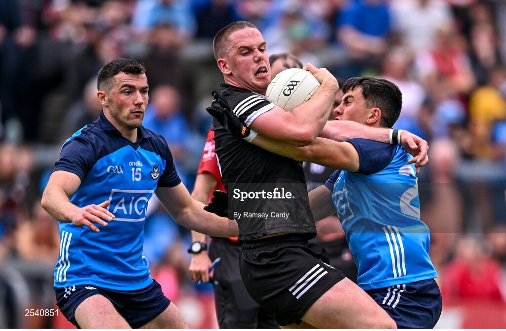 18 June 2023; Paul McNamara of Sligo is tackled by Colm Basquel, left, and Lorcan O'Dell of Dublin during the GAA Football All-Ireland Senior Championship Round 3 match between Dublin and Sligo at Kingspan Breffni in Cavan. Photo by Ramsey Cardy/Sportsfile