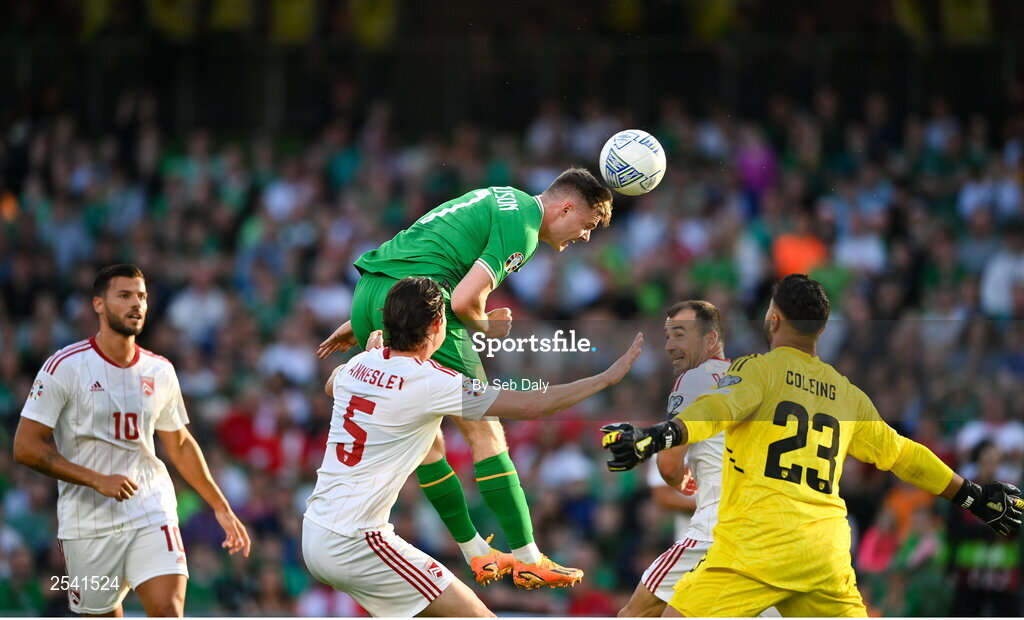 19 June 2023; Evan Ferguson of Republic of Ireland has a header on goal despite the attempts of Louie Annesley of Gibraltar during the UEFA EURO 2024 Championship qualifying group B match between Republic of Ireland and Gibraltar at the Aviva Stadium in Dublin. Photo by Seb Daly/Sportsfile