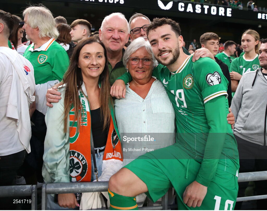 19 June 2023; Mikey Johnston of Republic of Ireland with his family, from left, sister Joanne, dad Robert, and mum Janette after the UEFA EURO 2024 Championship qualifying group B match between Republic of Ireland and Gibraltar at the Aviva Stadium in Dublin. Photo by Michael P Ryan/Sportsfile
