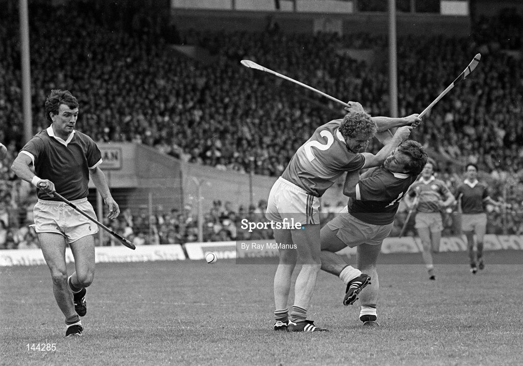 15 July 1984; Seanie O'Leary of Cork, assisted by teammate Jimmy Barry Murphy, is tackled by Jack Bergin of Tipperary. Munster Hurling Final, Tipperary v Cork, Semple Stadium, Thurles, Co. Tipperary. Picture credit; Ray McManus / SPORTSFILE