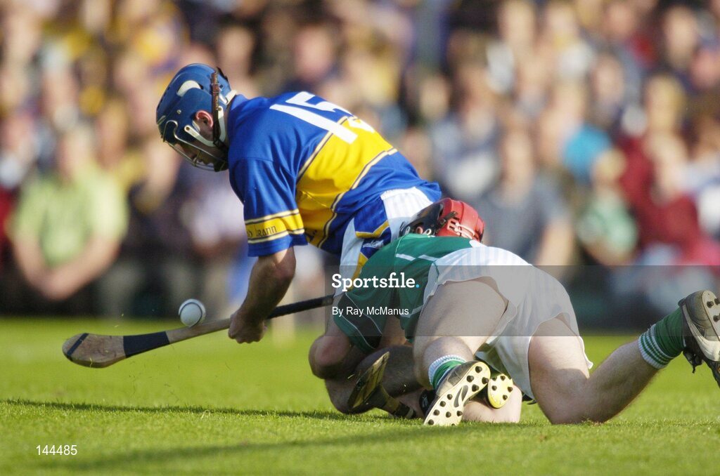 26 June 2004; Eoin Kelly,Tipperary, is tackled by Damien Reale, Tipperary. Guinness Senior Hurling Championship Qualifier, Round 1, Limerick v Tipperary, Gaelic Grounds, Limerick. Picture credit; Ray McManus / SPORTSFILE