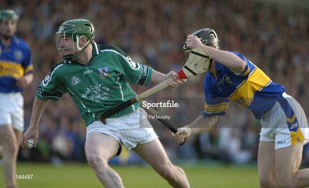 26 June 2004; John Paul Sheehan, Limerick, is tackled by Paul Curran, Tipperary. Guinness Senior Hurling Championship Qualifier, Round 1, Limerick v Tipperary, Gaelic Grounds, Limerick. Picture credit; Pat Murphy / SPORTSFILE