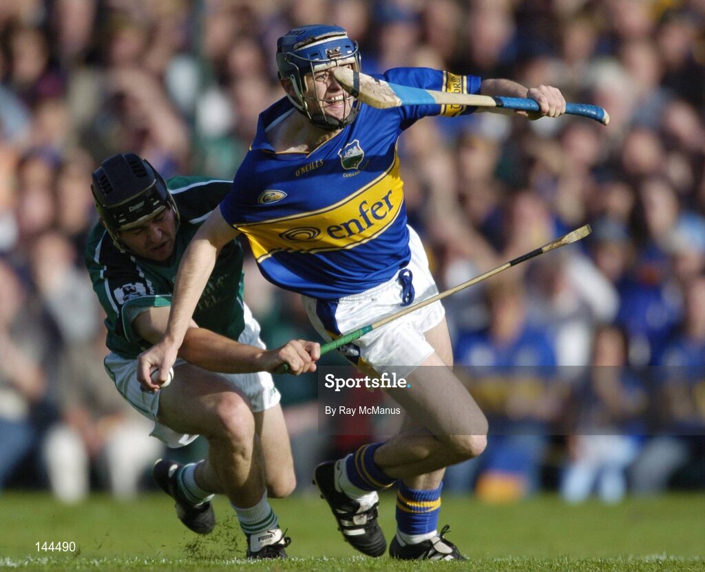 26 June 2004; Paul Kelly,Tipperary, is tackled by TJ Ryan, Limerck. Guinness Senior Hurling Championship Qualifier, Round 1, Limerick v Tipperary, Gaelic Grounds, Limerick. Picture credit; Ray McManus / SPORTSFILE