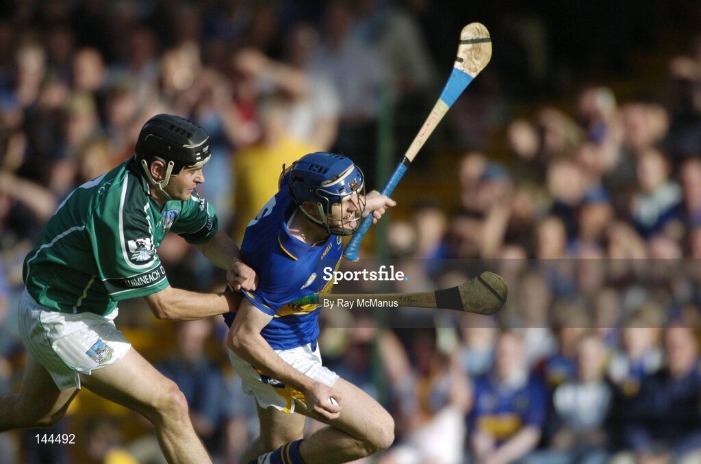 26 June 2004; Paul Kelly, Tipperary, is tackled by TJ Ryan, Limerick. Guinness Senior Hurling Championship Qualifier, Round 1, Limerick v Tipperary, Gaelic Grounds, Limerick. Picture credit; Ray McManus / SPORTSFILE