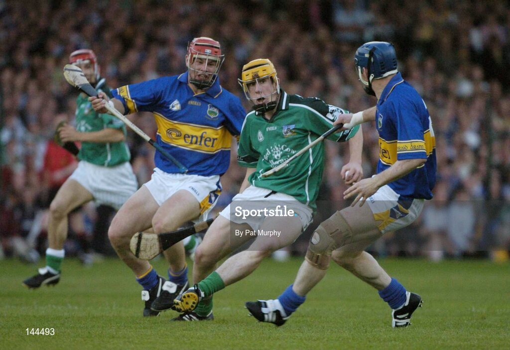 26 June 2004; Niall Moran, Limerick, is tackled by Diarmuid Fitzgerald, left, and Martin Maher, Tipperary. Guinness Senior Hurling Championship Qualifier, Round 1, Limerick v Tipperary, Gaelic Grounds, Limerick. Picture credit; Pat Murphy / SPORTSFILE