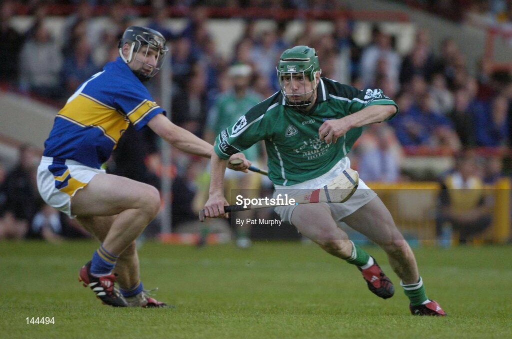 26 June 2004; Andrew O'Shaughnessy, Limerick, is tackled by Philip Maher, Tipperary. Guinness Senior Hurling Championship Qualifier, Round 1, Limerick v Tipperary, Gaelic Grounds, Limerick. Picture credit; Pat Murphy / SPORTSFILE