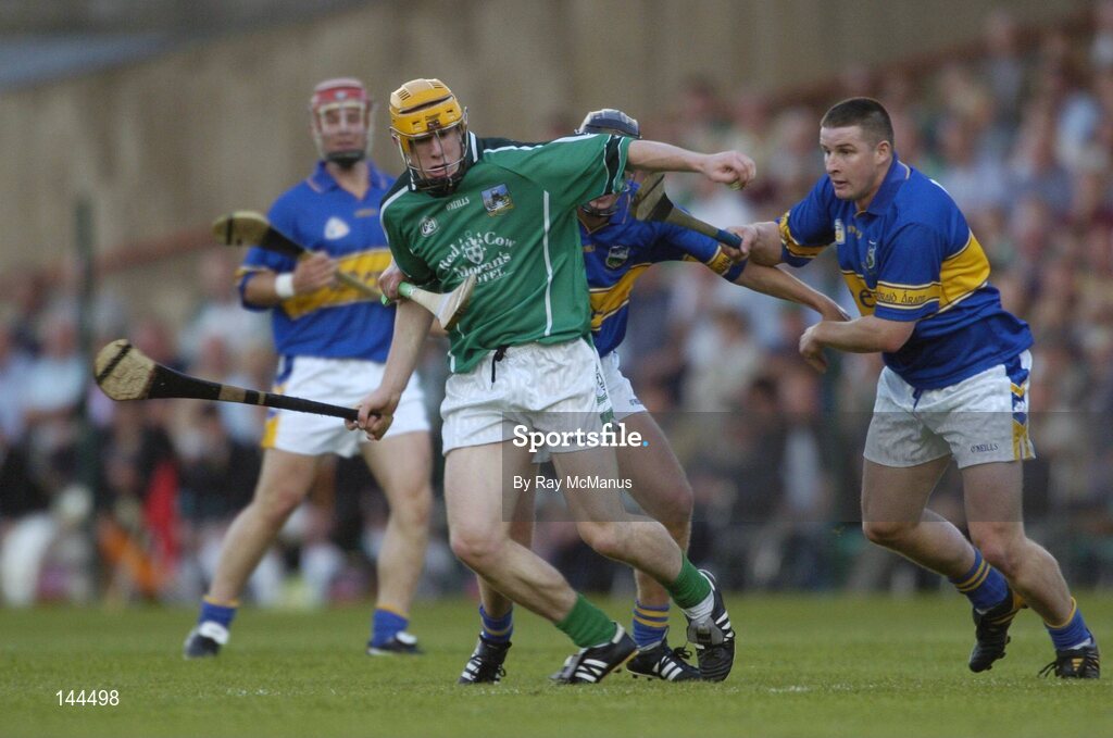 26 June 2004; Nial Moran, Limerick, in action against Eddie Enright, hidden, and John Carroll, Tipperary. Guinness Senior Hurling Championship Qualifier, Round 1, Limerick v Tipperary, Gaelic Grounds, Limerick. Picture credit; Ray McManus / SPORTSFILE
