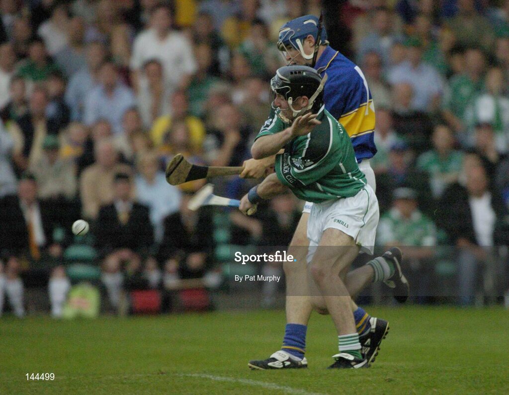 26 June 2004; Seamus Butler, Tipperary, scores his sides third goal despite the attentions of Mickey Cahill, Limerick. Guinness Senior Hurling Championship Qualifier, Round 1, Limerick v Tipperary, Gaelic Grounds, Limerick. Picture credit; Pat Murphy / SPORTSFILE