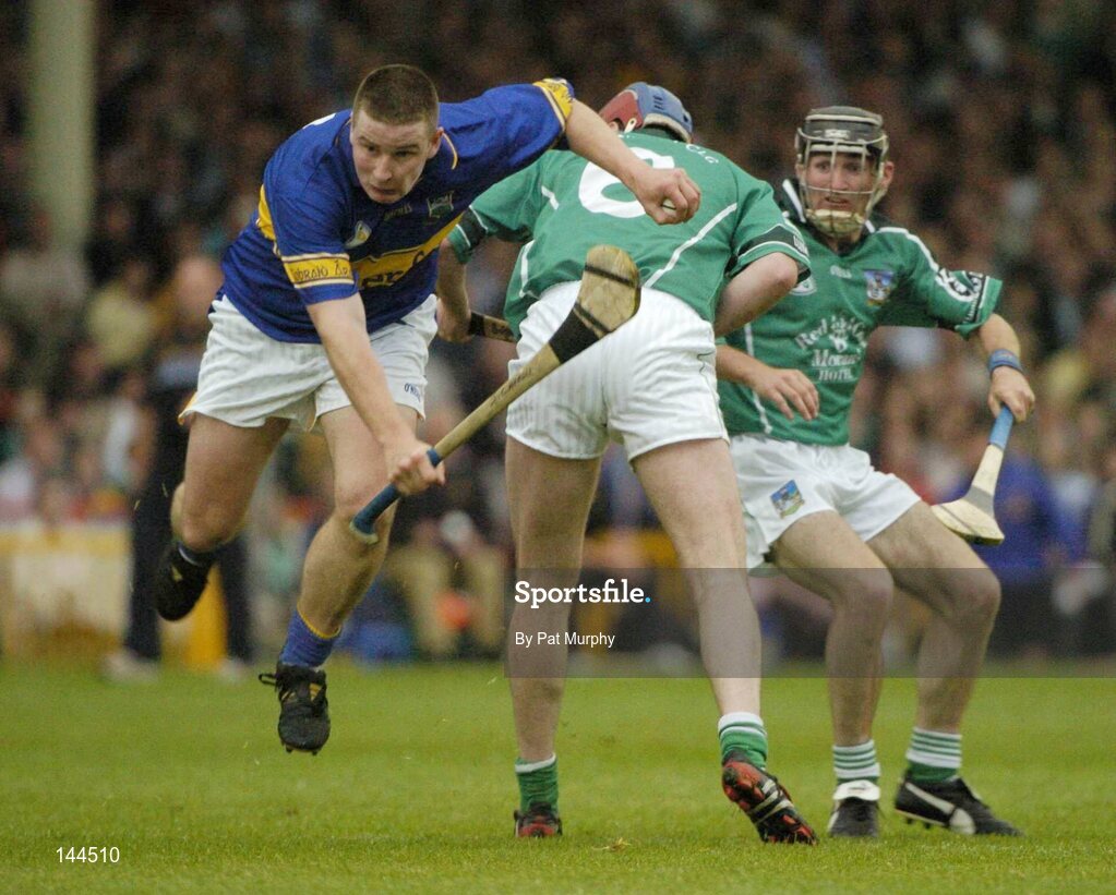 26 June 2004; John Carroll, Tipperary, is tackled by Brian Geary, Limerick. Guinness Senior Hurling Championship Qualifier, Round 1, Limerick v Tipperary, Gaelic Grounds, Limerick. Picture credit; Pat Murphy / SPORTSFILE