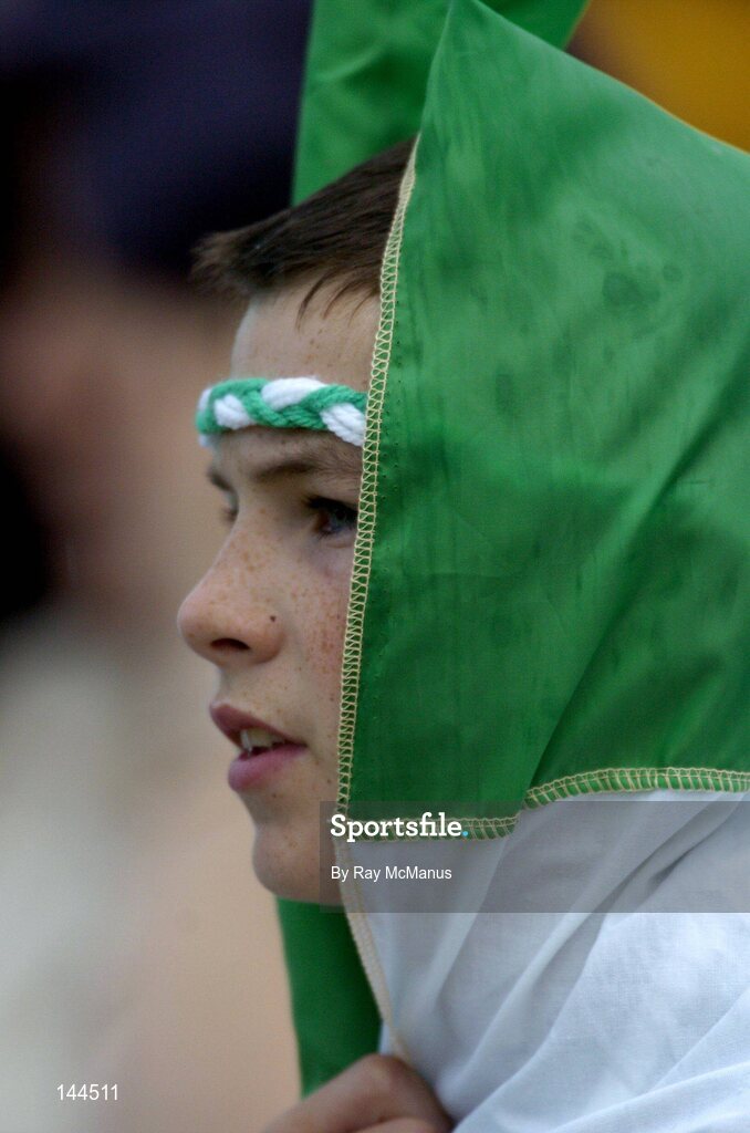 26 June 2004; Twelve year old Barry O'Connor from Kilfinnan, Co. Limerick, shelters from the rain. Guinness Senior Hurling Championship Qualifier, Round 1, Limerick v Tipperary, Gaelic Grounds, Limerick. Picture credit; Ray McManus / SPORTSFILE