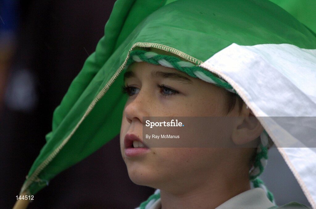 26 June 2004; Twelve year old Barry O'Connor from Kilfinnan, Co. Limerick, shelters from the rain. Guinness Senior Hurling Championship Qualifier, Round 1, Limerick v Tipperary, Gaelic Grounds, Limerick. Picture credit; Ray McManus / SPORTSFILE