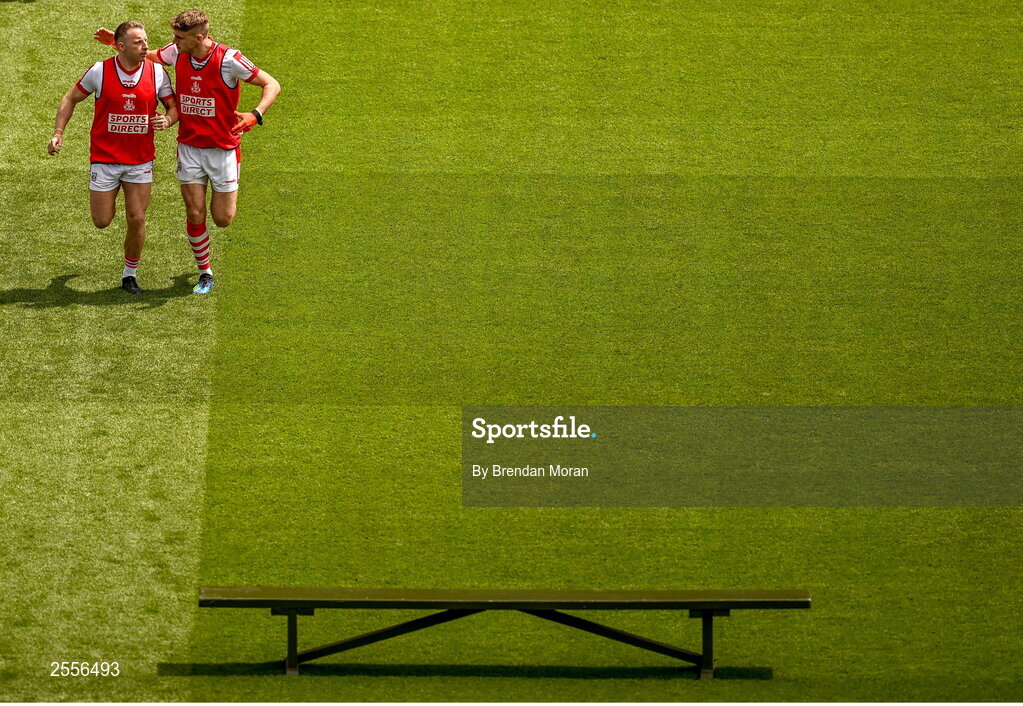 2 July 2023; Brian Hurley, left, and Colm O'Callaghan of Cork make their way to the bench for the team photograph before the GAA Football All-Ireland Senior Championship quarter-final match between Derry and Cork at Croke Park in Dublin. Photo by Brendan Moran/Sportsfile
