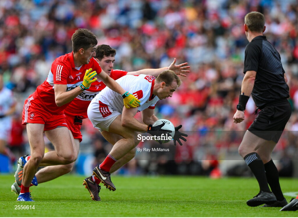2 July 2023; Referee Joe McQuillan keeps an eye on Matty Taylor of Cork as he is tackled by Padraig McGrogan and Paul Cassidy of Derry during the GAA Football All-Ireland Senior Championship quarter-final match between Derry and Cork at Croke Park in Dublin. Photo by Ray McManus/Sportsfile