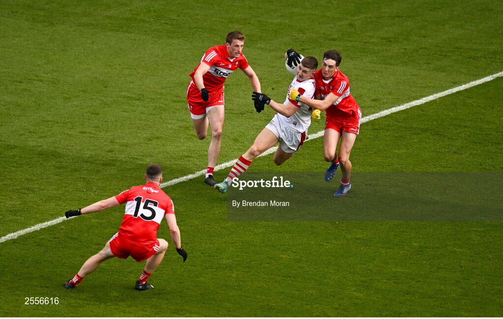 2 July 2023; Conor Corbett of Cork in action against Derry players, from left, Niall Loughlin, Brendan Rogers and Paul Cassidy during the GAA Football All-Ireland Senior Championship quarter-final match between Derry and Cork at Croke Park in Dublin. Photo by Brendan Moran/Sportsfile