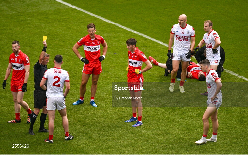 2 July 2023; Referee Joe McQuillan shows a yellow card to Maurice Shanley of Cork for a tackle on Gareth McKinless of Derry during the GAA Football All-Ireland Senior Championship quarter-final match between Derry and Cork at Croke Park in Dublin. Photo by Brendan Moran/Sportsfile