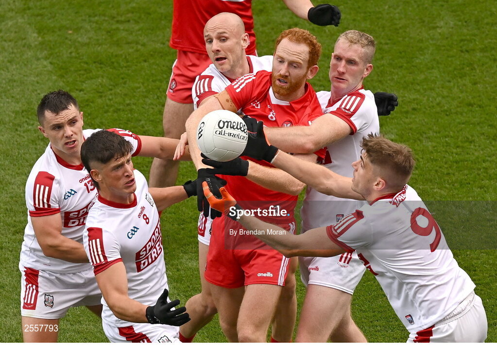 2 July 2023; Conor Glass of Derry competes with Cork players, from left, Colm O'Callaghan, Sean Powter, Brian O'Driscoll, Ruairi Deane and Ian Maguire for a dropping ball during the GAA Football All-Ireland Senior Championship quarter-final match between Derry and Cork at Croke Park in Dublin. Photo by Brendan Moran/Sportsfile