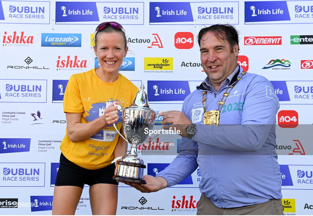 16 July 2023; Ciara Hickey of Brothers Pearse AC, Dublin, is presented with the cup by Mayor of Fingal, Councillor Adrian Henchy, after winning the women's race during the 2023 Irish Life Dublin Race Series-Fingal 10km which took place on Sunday 16th of July at Swords in Dublin. Photo by Sam Barnes/Sportsfile