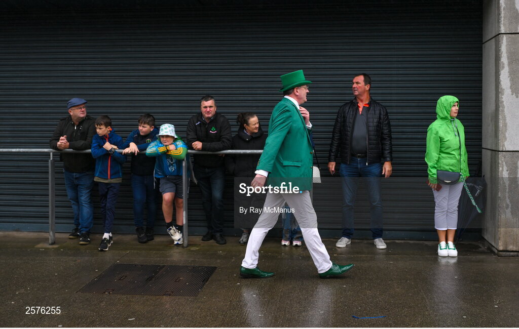 23 July 2023; Supporters take shelter as a Limerick supporter arrives for the GAA Hurling All-Ireland Senior Championship final match between Kilkenny and Limerick at Croke Park in Dublin. Photo by Ray McManus/Sportsfile