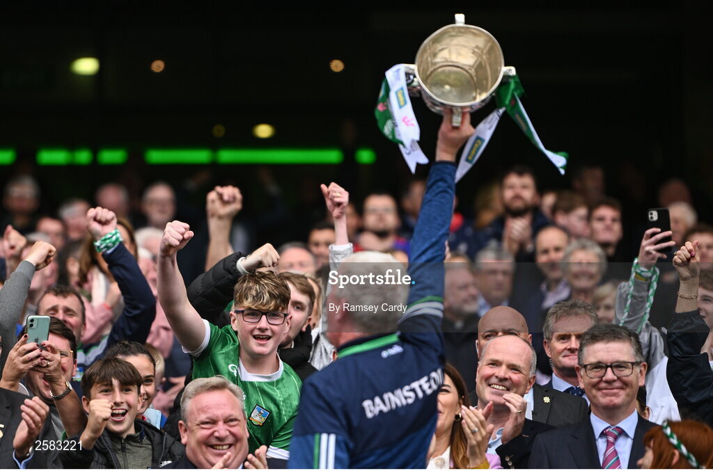 23 July 2023; Supporters celebrate as Limerick manager John Kiely lifts the Liam MacCarthy Cup after the GAA Hurling All-Ireland Senior Championship final match between Kilkenny and Limerick at Croke Park in Dublin. Photo by Ramsey Cardy/Sportsfile