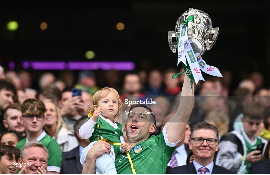 23 July 2023; Limerick player Graeme Mulcahy, with his daughter Róise, lifts the Liam MacCarthy Cup after the GAA Hurling All-Ireland Senior Championship final match between Kilkenny and Limerick at Croke Park in Dublin. Photo by Ramsey Cardy/Sportsfile