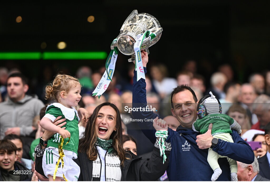 23 July 2023; Limerick selector Paul Kinnerk, with wife Maggie, and their children Paul, 4 weeks, and Enya, age 4, lifts the Liam MacCarthy Cup after the GAA Hurling All-Ireland Senior Championship final match between Kilkenny and Limerick at Croke Park in Dublin. Photo by Ramsey Cardy/Sportsfile