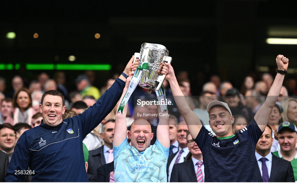 23 July 2023; Limerick analysts Kieran Hickey, left, Sean O'Donnell, centre, and Ruairí Maher lift the Liam MacCarthy Cup after the GAA Hurling All-Ireland Senior Championship final match between Kilkenny and Limerick at Croke Park in Dublin. Photo by Ramsey Cardy/Sportsfile
