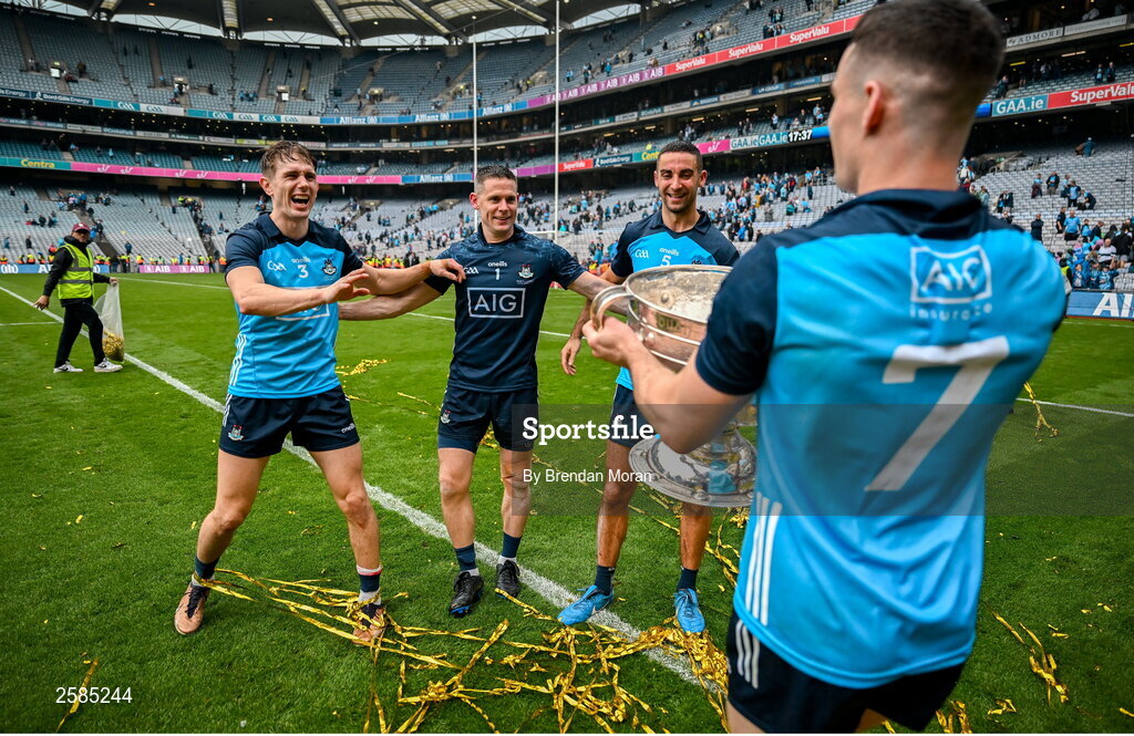 30 July 2023; Dublin players and record 9 time All-Ireland winning medallists, from left, captain James McCarthy, Stephen Cluxton and Michael Fitzsimons celebrate with teammate Lee Gannon, right, and the Sam Maguire Cup after the GAA Football All-Ireland Senior Championship final match between Dublin and Kerry at Croke Park in Dublin. Photo by Brendan Moran/Sportsfile