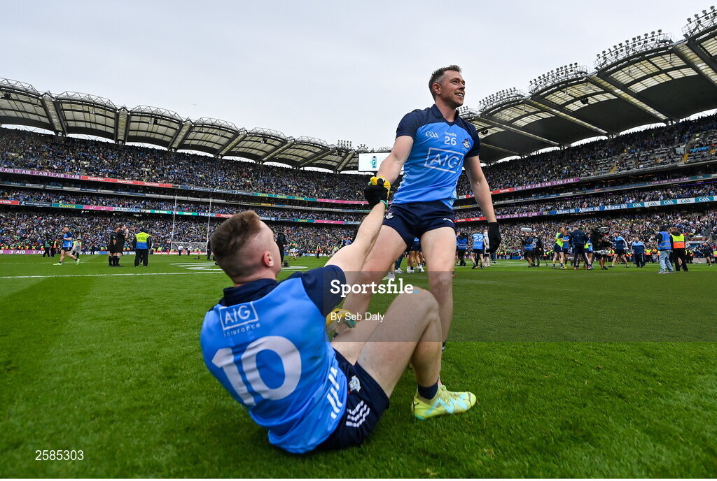 30 July 2023; Paddy Small of Dublin, left, is helped from the floor by teammate Dean Rock after their side's victory in the GAA Football All-Ireland Senior Championship final match between Dublin and Kerry at Croke Park in Dublin. Photo by Seb Daly/Sportsfile